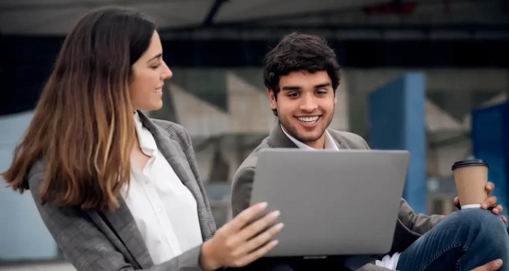 People with laptop outdoors medium shot