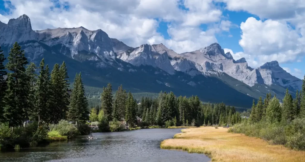 Beautiful shot of a river through the village surrounded by hills, mountains and greenery