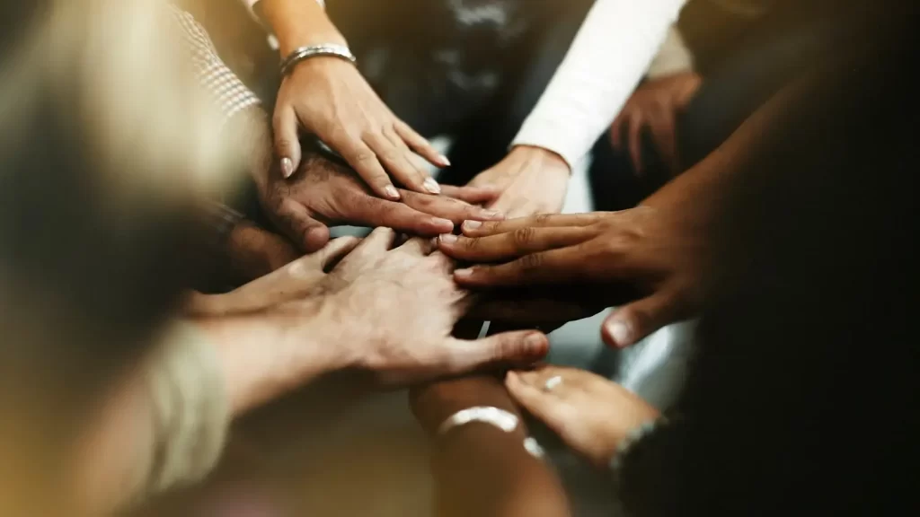 closeup-diverse-people-joining-their-hands