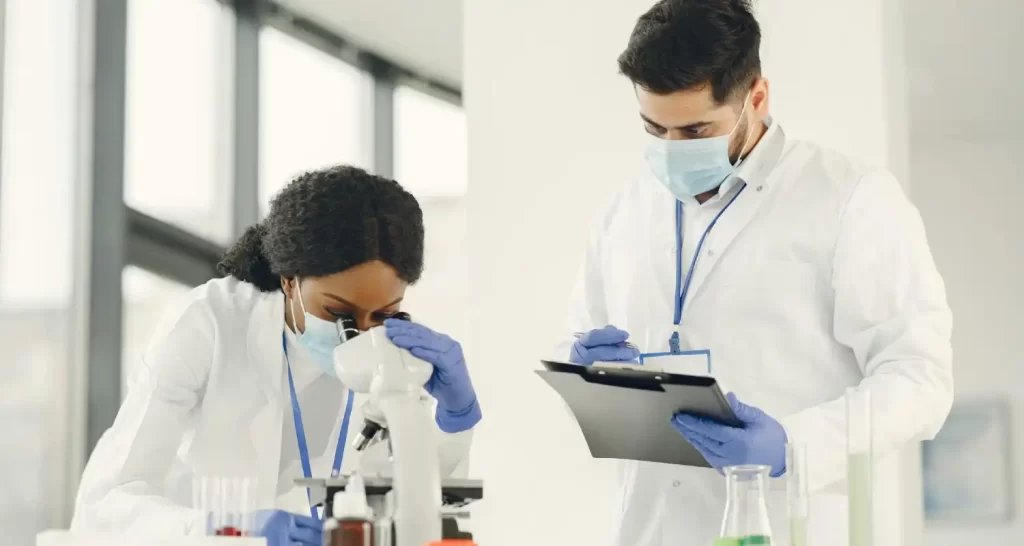 Man and Woman Wearing White Lab Coat Doing Laboratory Analysis