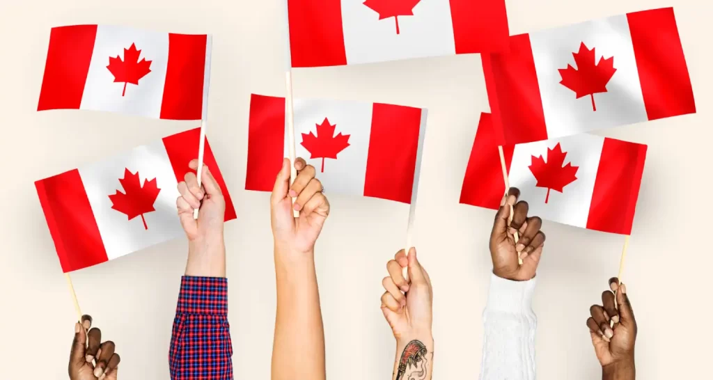 Hands waving flags of Canada