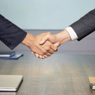 Crop people shaking hands on conference