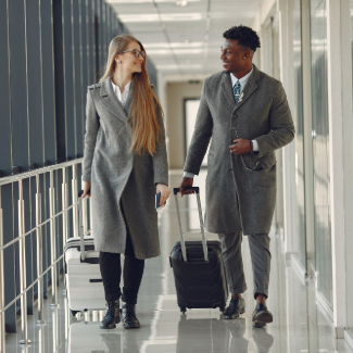 Elegant black man at the airport with his businesspartner