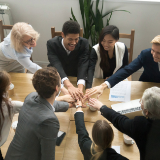 Multiracial business people put hands together at group team meeting
