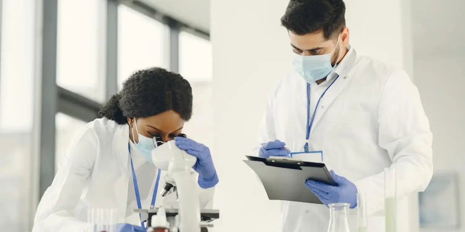 Man and Woman Wearing White Lab Coat Doing Laboratory Analysis