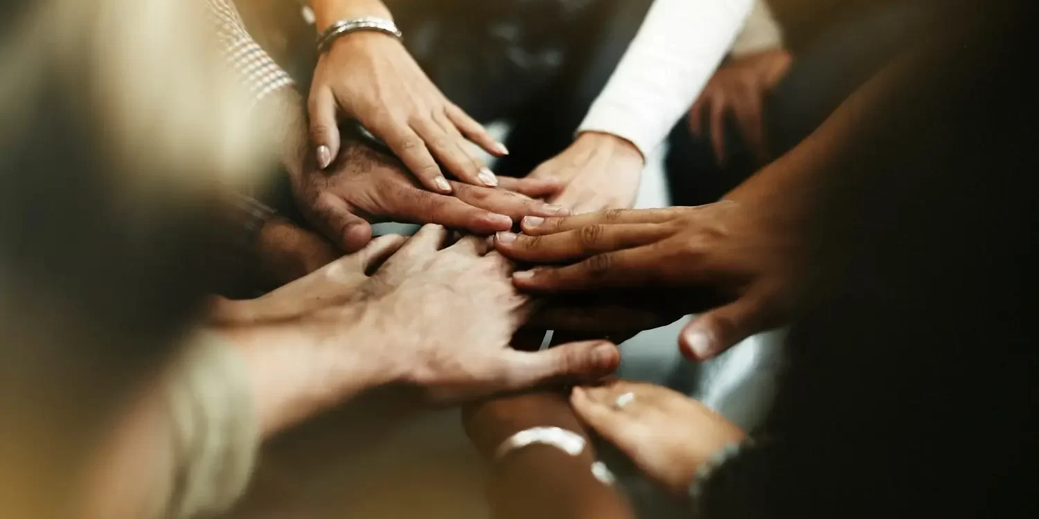 closeup-diverse-people-joining-their-hands